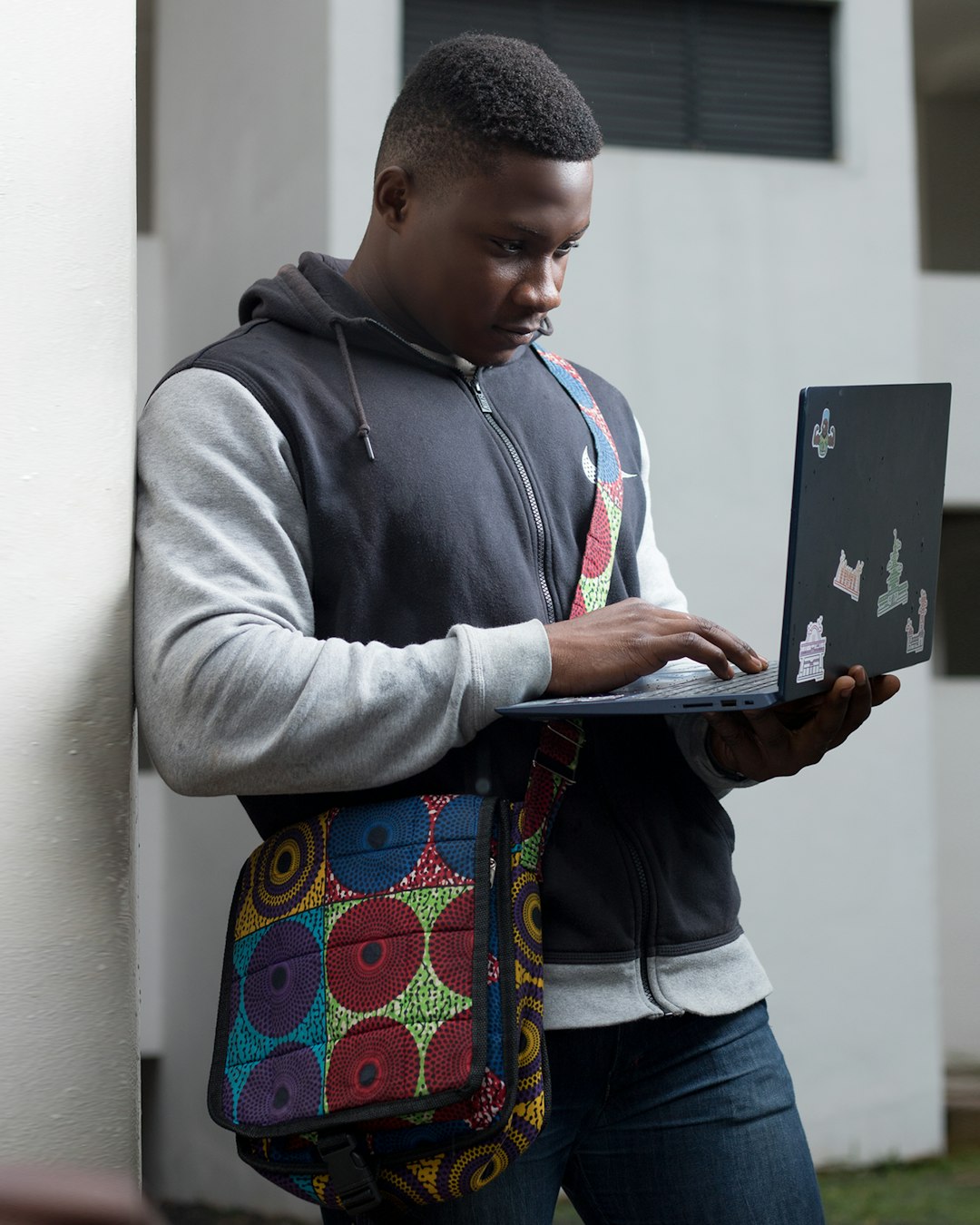 Black COllege student holding laptop
