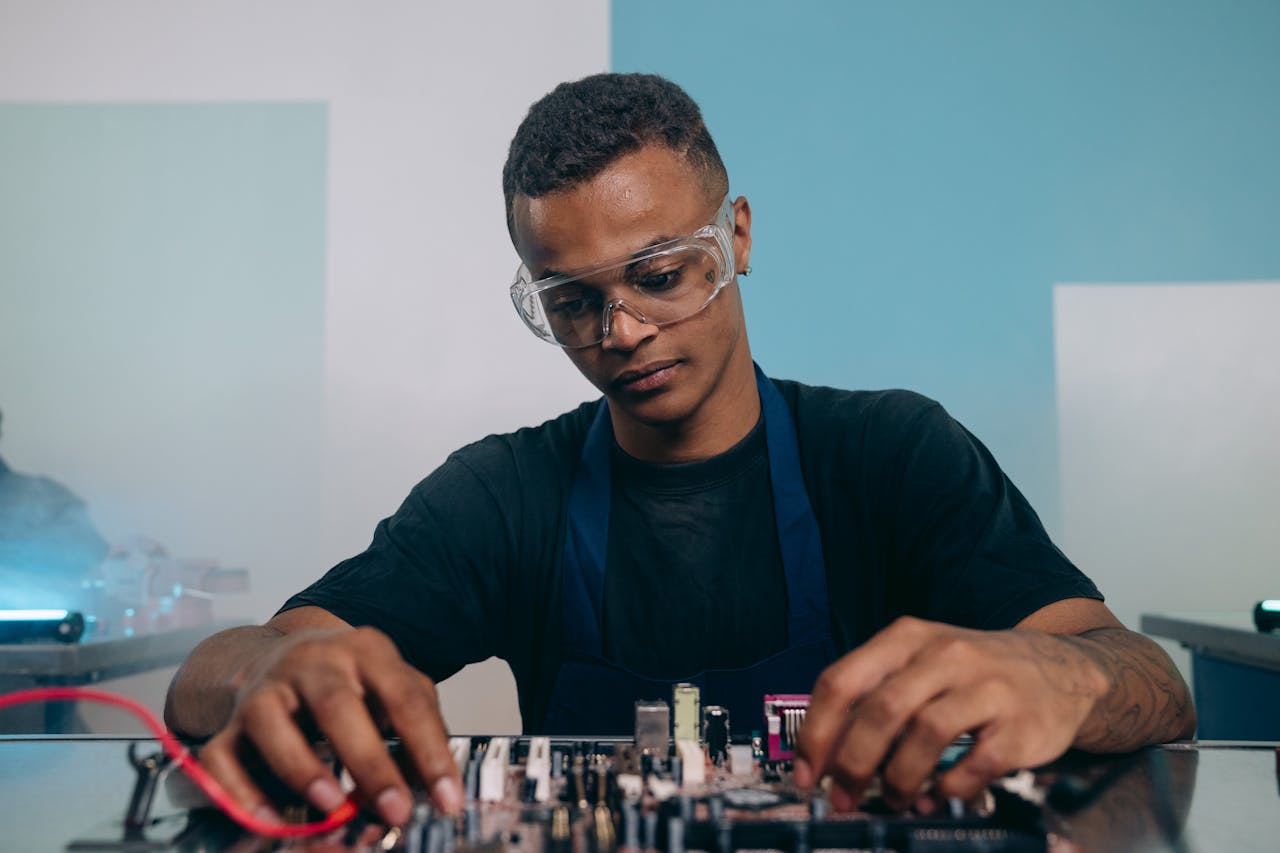 Focused electronics engineer assembling a circuit board with precision and attention to detail.